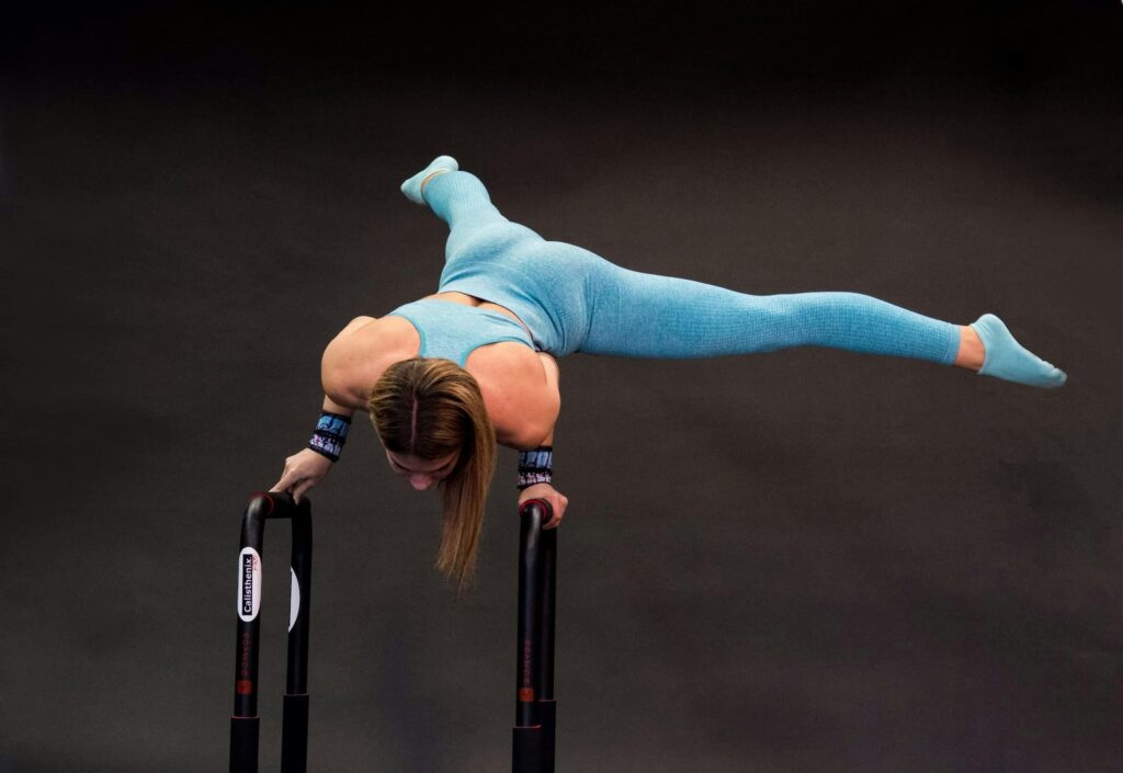 A woman performing a calisthenics push-up on a workout mat at home, demonstrating bodyweight strength and discipline."